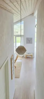 a living room with a couch and a table at Modern House Close To The North Sea in Tranum