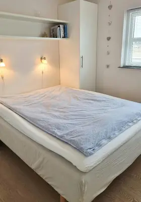 a large bed in a white room with a mattress at Modern House Close To The North Sea in Tranum