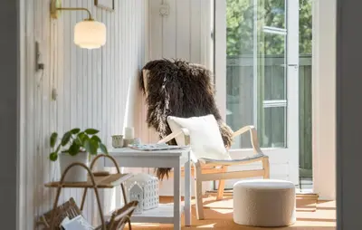 a room with a chair and a table and a window at 3 Bedroom Stunning Home In Blokhus in Blokhus