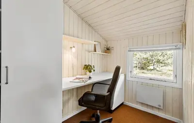 a desk in a tiny house with a chair at 3 Bedroom Stunning Home In Blokhus in Blokhus