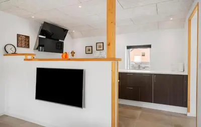 a living room with a fireplace and a tv at Stunning Home In Vemb With Wifi in Vemb