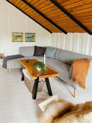 a living room with a couch and a table at Simple Cottage Close To Limfjorden in Åbybro