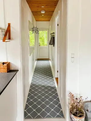 a hallway of a home with a white door at Simple Cottage Close To Limfjorden in Åbybro
