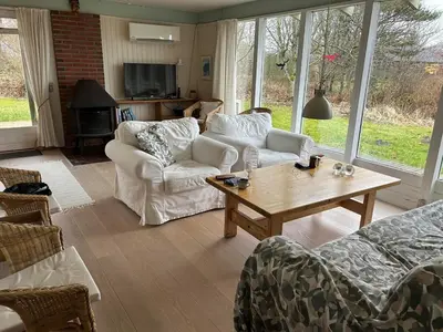 a living room with couches and a coffee table at Hygge in the North Sea Cabin in Fjerritslev