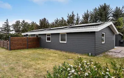 a black house with a fence in a yard at 3 Bedroom Beautiful Home In Thisted in Thisted