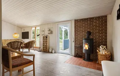 a living room with a brick wall and a fireplace at 3 Bedroom Beautiful Home In Thisted in Thisted