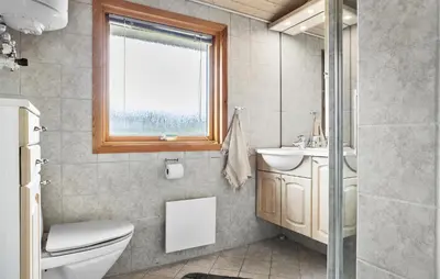 a bathroom with a toilet and a sink and a window at 3 Bedroom Beautiful Home In Thisted in Thisted