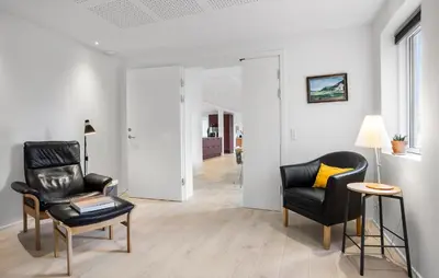 a living room with two chairs and a table at Gorgeous Home In Hurup Thy With Wifi in Sønder Ydby
