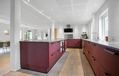 a large kitchen with red cabinets and a counter at Gorgeous Home In Hurup Thy With Wifi in Sønder Ydby