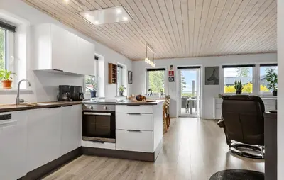 a kitchen with white cabinets and a stove top oven at 3 Bedroom Cozy Home In Højslev in Højslev
