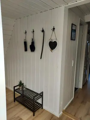 a room with a bench and guitars on a wall at Holiday home golf house in beautiful Himmerland Farsø in Farsø