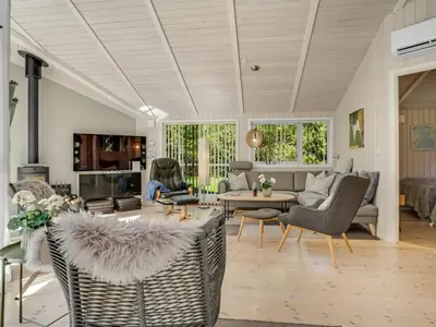 a living room with a couch and a table at Holiday Home Atti - 500m to the fjord by Interhome in Højslev