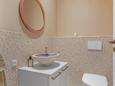 a bathroom with a sink and a mirror on the wall at Holiday Home Stjerne - 300m to the fjord by Interhome in Lemvig