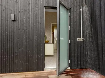 a bathroom with a shower and a glass door at Holiday Home Stjerne - 300m to the fjord by Interhome in Lemvig