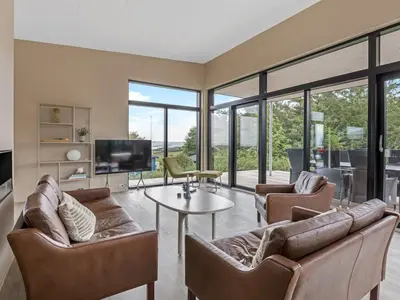 a living room with two couches and a tv at Holiday Home Stjerne - 300m to the fjord by Interhome in Lemvig
