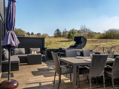 a patio with a table and chairs and a grill at Apartment Kauno - 16km to the fjord by Interhome in Farsø