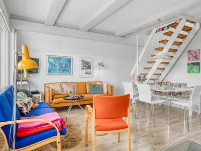 a living room with a couch and a table at Holiday Home Arkil - 200m from the sea by Interhome in Harboør