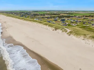 an aerial view of a beach with houses and condos at Holiday Home Arkil - 200m from the sea by Interhome in Harboør