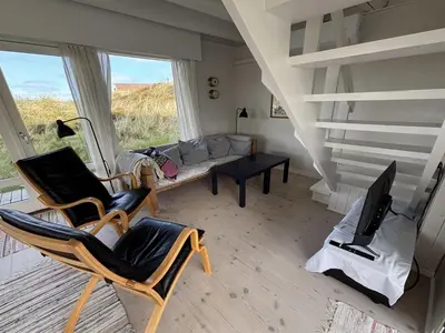 a living room with two chairs and a couch at Holiday Home Wighlek - 800m from the sea by Interhome in Snedsted