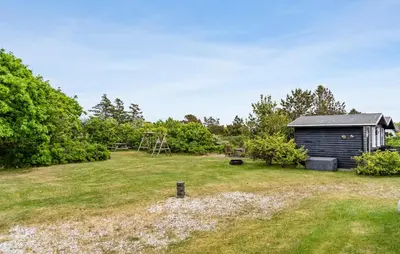 a garden with a shed and a playground at 5 Bedroom Awesome Home In Vestervig in Vestervig
