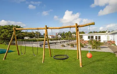 a playground with a swing set in a park at 5 Bedroom Awesome Home In Vestervig in Vestervig