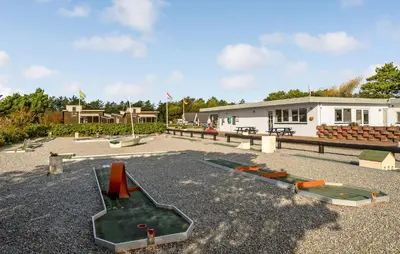 a group of playground equipment in front of a building at 5 Bedroom Awesome Home In Vestervig in Vestervig