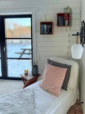 a bedroom with a bed with a pillow and a window at Traditional Summer House Near Blokhus Beach in Blokhus