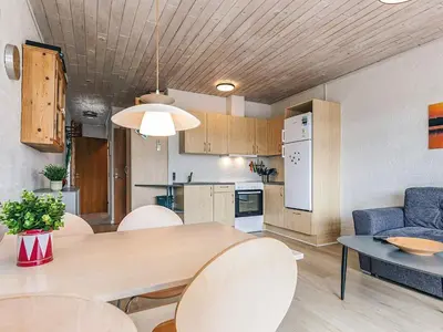 a kitchen and living room with a table and chairs at 4 person holiday home in Vestervig in Vestervig