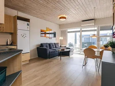 a kitchen and living room with a couch and a table at 4 person holiday home in Vestervig in Vestervig