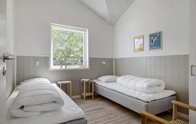 a bedroom with two beds and a window at Pet Friendly Home In Saltum With Sauna in Saltum