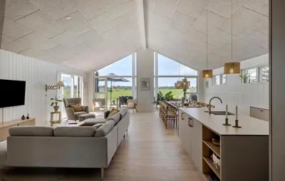 a large living room with a couch and a kitchen at Pet Friendly Home In Saltum With Sauna in Saltum