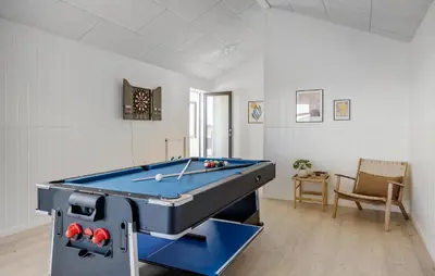 a pool table in a living room with a table at Pet Friendly Home In Saltum With Sauna in Saltum