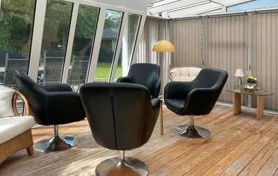 a waiting room with black chairs and a table at 2 Bedroom Cozy Home In Farsø in Farsø