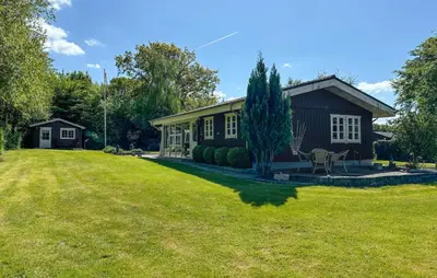 a house with a large yard in front of it at 2 Bedroom Cozy Home In Farsø in Farsø