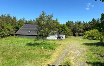 a cabin in the middle of a field with a tree at 3 Bedroom Cozy Home In Fur in Furland