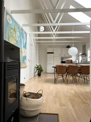 a large living room with a table and chairs at Stalden ved Hjarbækgård in Løgstrup