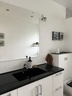 a kitchen with a sink and a mirror at Stalden ved Hjarbækgård in Løgstrup