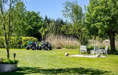 a park with two atvs parked in the grass at Lovely Home In Nibe With Lake View in Nibe