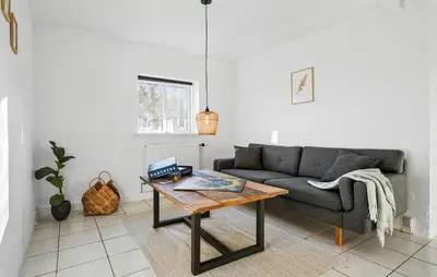 a living room with a couch and a coffee table at Lovely Home In Nibe With Lake View in Nibe