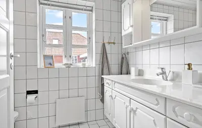 a white bathroom with a sink and a window at Gorgeous Home In Vestervig With Wifi in Vestervig