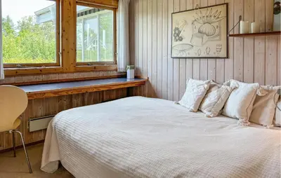 a bedroom with a white bed with a window at 3 Bedroom Stunning Home In Øster Assels in Øster Assels