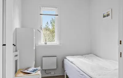 a white bedroom with a bed and a window at Amazing Home In Løkken With Wifi in Løkken