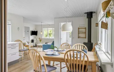 a kitchen and dining room with a table and chairs at Amazing Home In Løkken With Wifi in Løkken