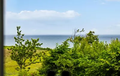 a view of the ocean from behind some trees at 3 Bedroom Amazing Home In Fur in Fur
