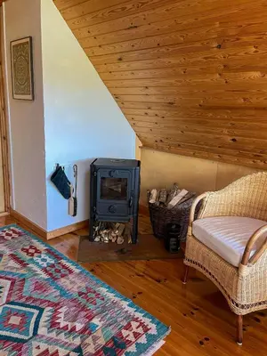 a living room with a wood stove and a couch at Architect-Designed Holiday Home By Saltum Beach in Saltum
