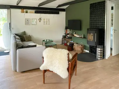 a living room with a couch and a fireplace at Family House By Frederik Vii Canal In Løgstør in Løgstør