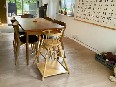 a wooden table and chairs with a calendar on the wall at Family House By Frederik Vii Canal In Løgstør in Løgstør
