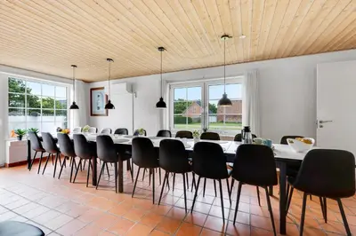 a large dining room with a long table and chairs at Large Pool House For 24 People, With Almost Everything In Activities, 300 Meters From The Fjord in Vinderup