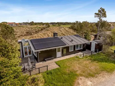 an aerial view of a house with solar panels on it at Well-Maintained Holiday Home With Outdoor Shower And 5-Person Outdoor Hot Tub, Close To The North Sea In Klitmøller in Klitmøller