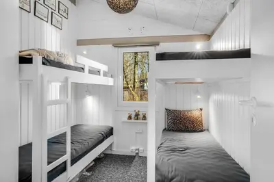a bedroom with two bunk beds in a house at Lovely Renovated Holiday Home With A Wilderness Bath And Fenced Grounds in Vesløs